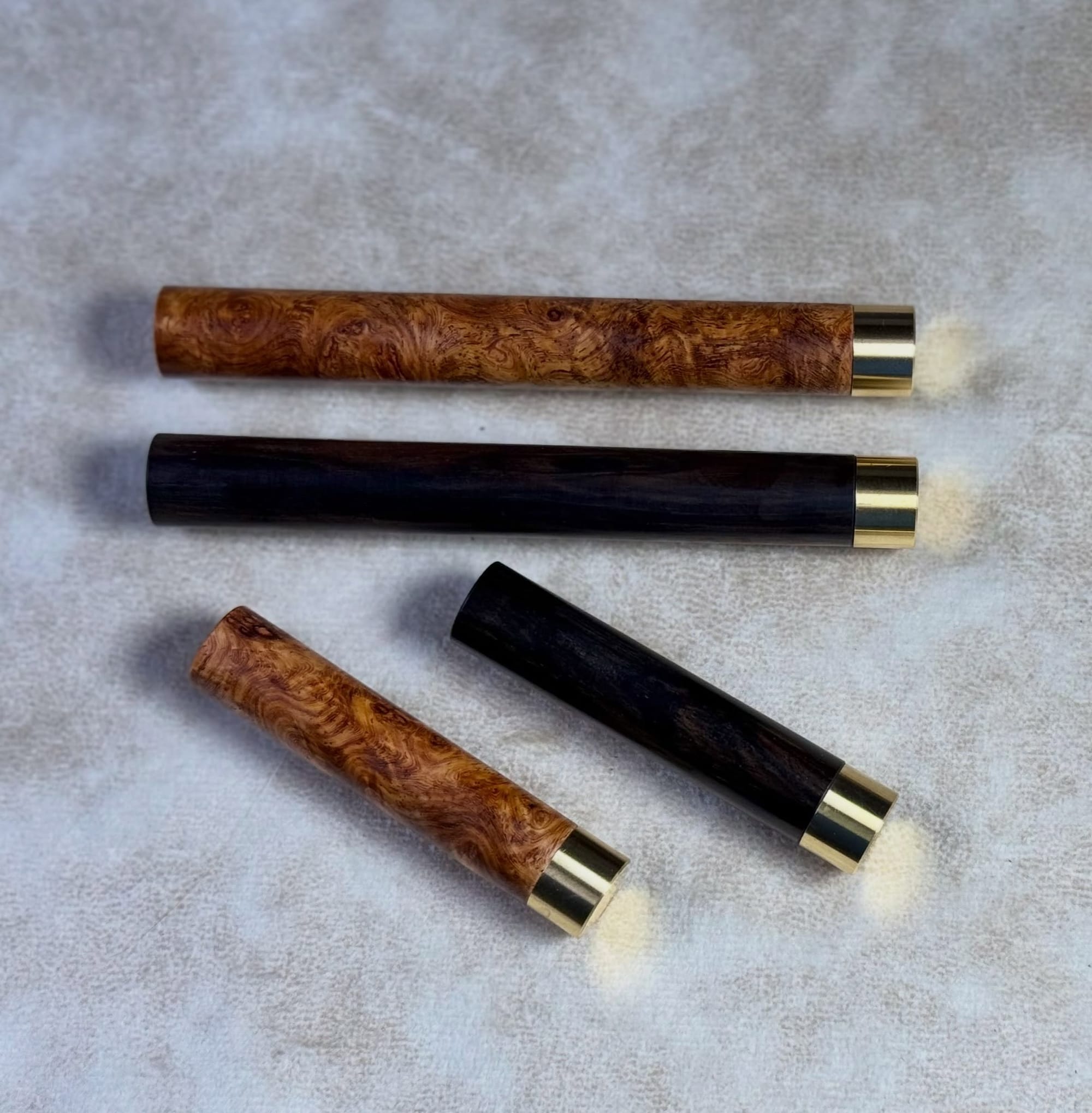 Wooden Craft A refill cases in two sizes, closed on a gray surface.