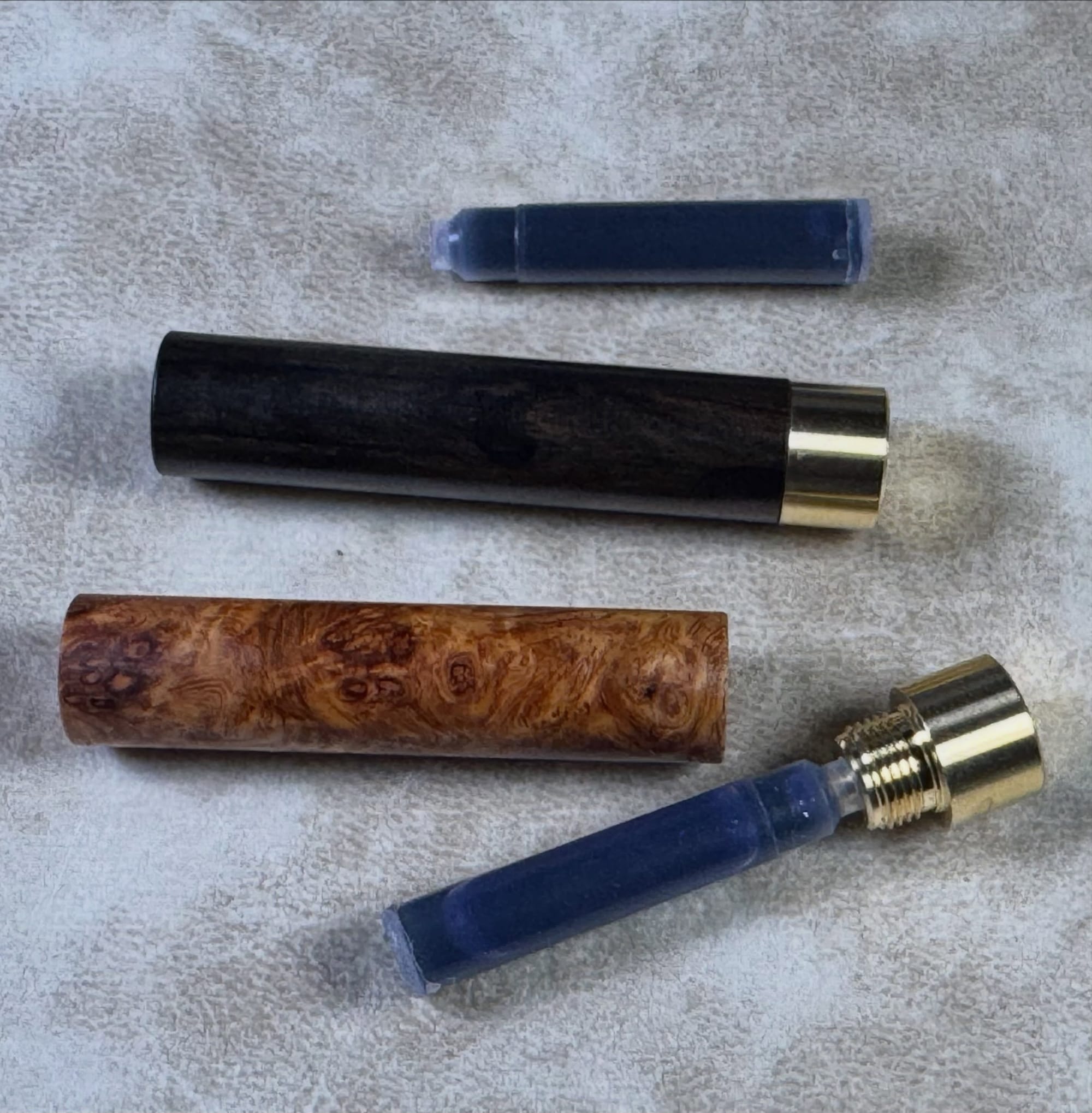 Smaller Craft A wooden cases holding short ink cartridges.