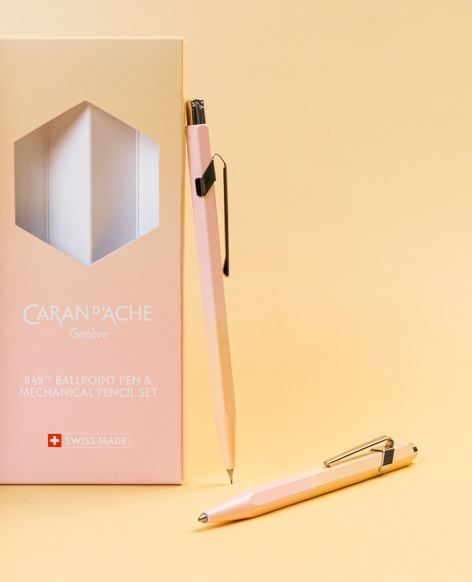 The pink-and-yellow 849 Horizon mechanical pencil beside its gift box, with the matching ballpoint lying in front